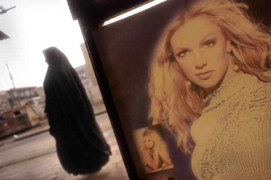 Iraqi Porn Star - An Iraqi woman walks past a poster of (U.S. pop star) Britney Spears,