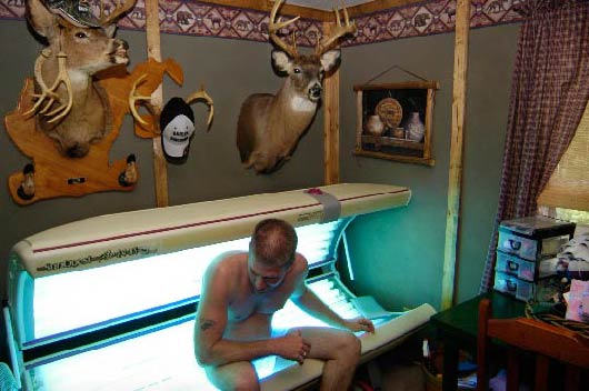 Cary Mark Arthur in Pam Ranson's tanning bed, Liberty, W.Va. 
