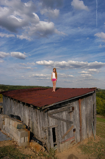 Sierra Arthur on the roof of her parents' woodshed, Liberty, West Virginia
